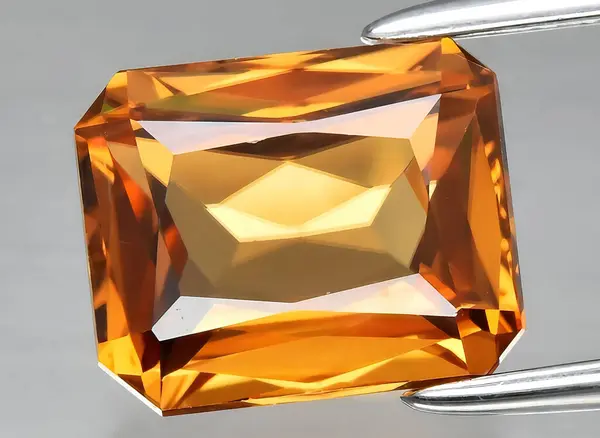 natural yellow zircon gem on background