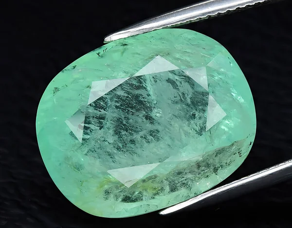 natural green emerald beryl gem on background