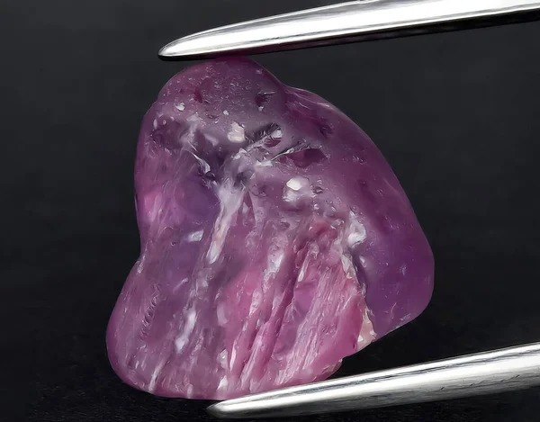 natural purple sapphire rough gem on background