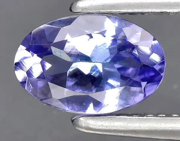 natural blue tanznaite gem on background