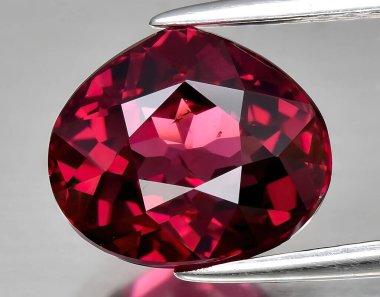 Arka planda doğal kırmızı mor rodolit taşlı mücevher.