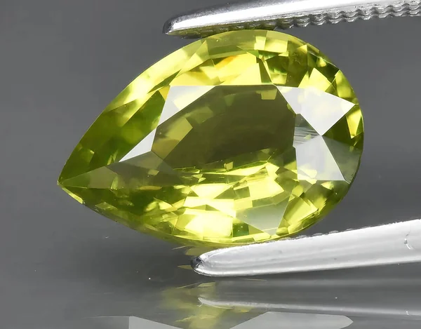 natural green peridot chrysolite gem on background