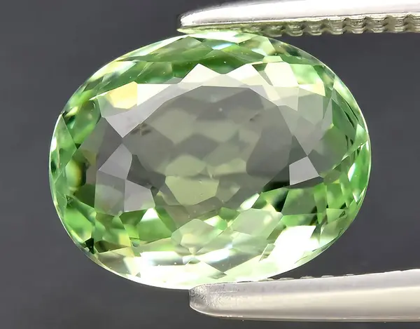 natural green tourmaline verdelite gem on background