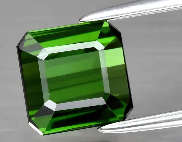 natural green tourmaline verdelite gem on background