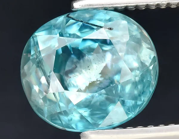 natural blue zircon gem on background