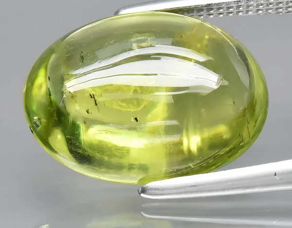 natural green peridot olivine gem on background
