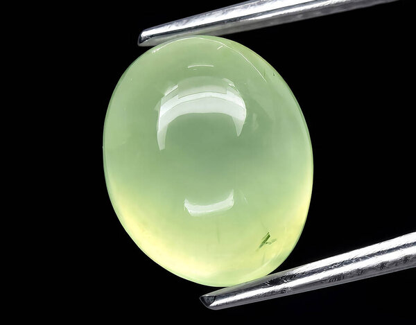 natural green prehnite gem on background