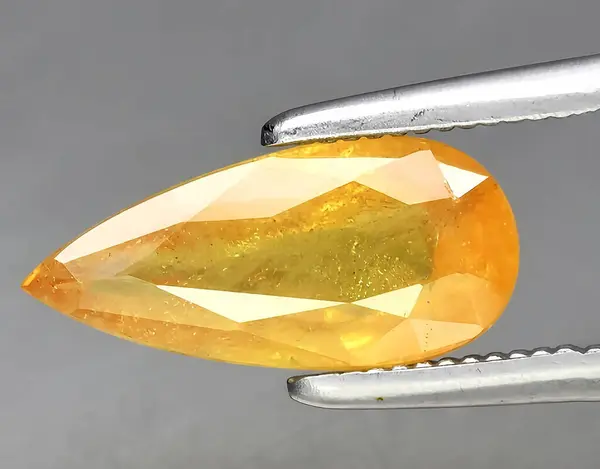natural orange sapphire gem on background