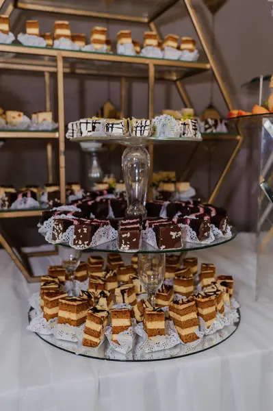 Sweet cakes at a wedding banquet. Catering, sweet festive buffet. Chocolate bar. Mousse cakes