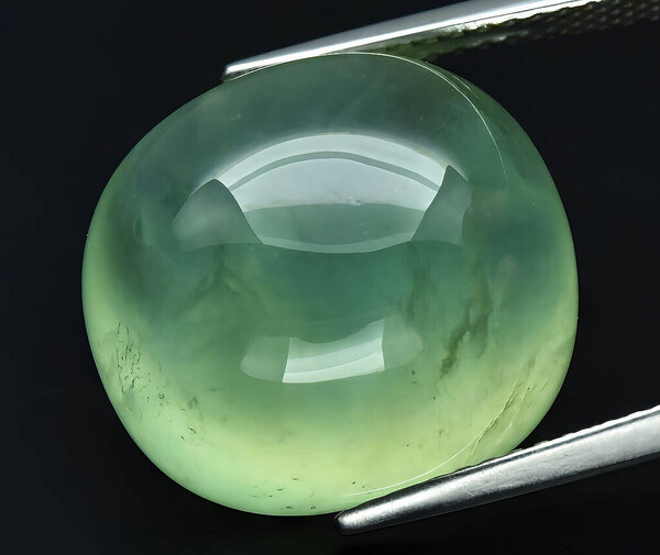 natural green prehnite gem on background