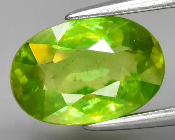natural green sphene titanite gem on background