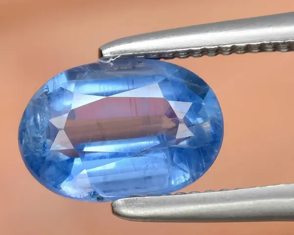 natural blue iolite gem on background