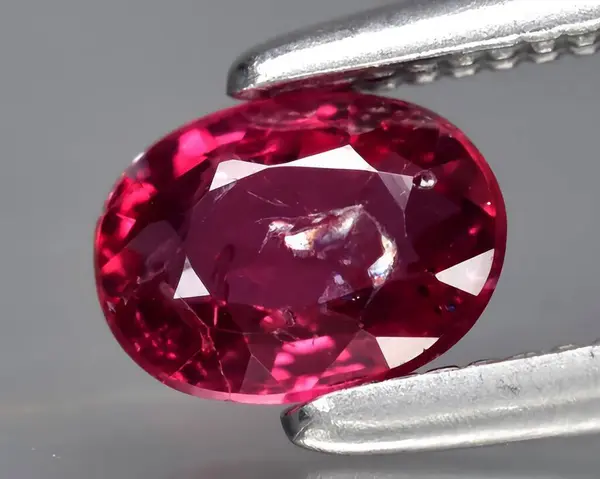 natural pink red ruby gem on background
