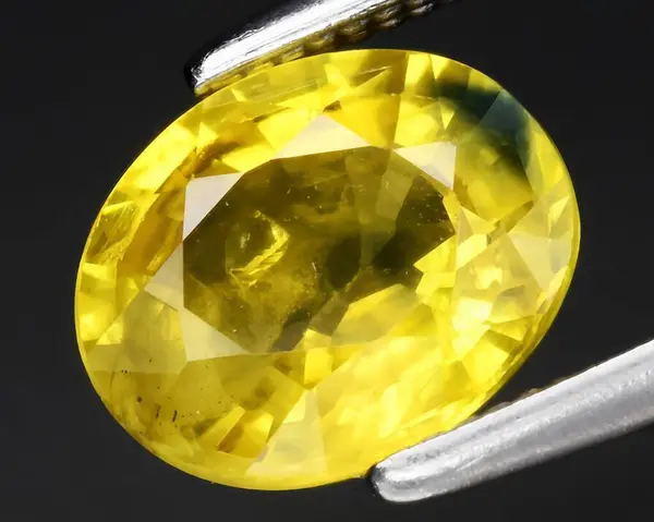 natural yellow sapphire gem on background