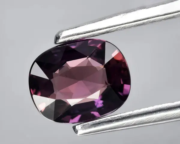 natural purple sapphire gem on background