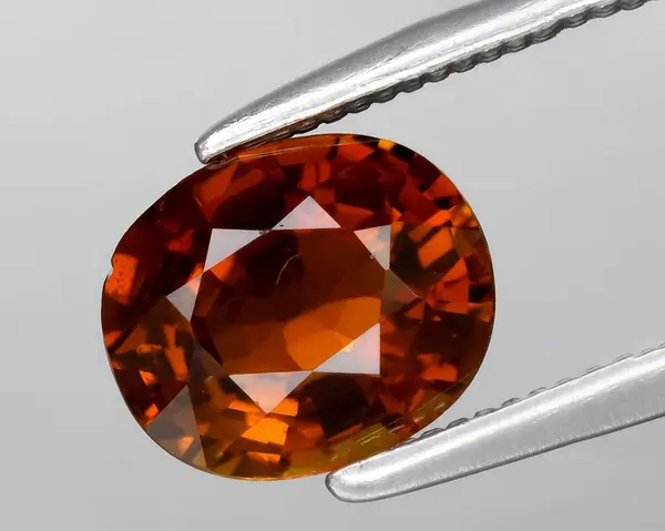 stock image natural orange tourmaline gem on background