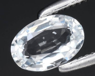 natural white goshenite beryl gem on background