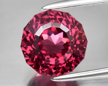 natural pink red rhodolite gem on background clipart