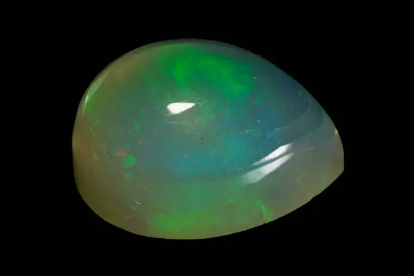 stock image natural rainbow opal gem isolated on the black background