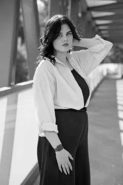 stock image Business woman in black trousers and white shirt. Business lady in a black business suit against the background of a business center