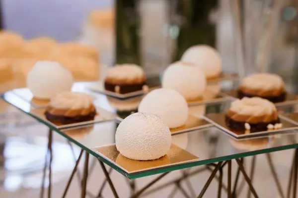 stock image Elegant Display of Exquisite Pastry Creations on a Modern Glass Stand.