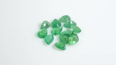 Beyaz bir yüzeyde parlayan parlak yeşil Gemstone 'lar.