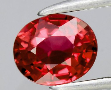 Radiant Red Spinel Gemstone in Silver Settings Highlighting Its Intricate Cut and Shine. clipart