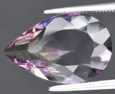 Exquisite Natural Pear-Shaped Amethyst Gemstone with Iridescent Color Variations and Faceted Edges. clipart