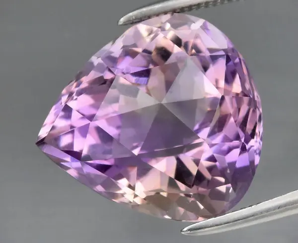 stock image Exquisite Amethyst Gemstone Cut in Heart Shape Displaying Vibrant Purple Hue with Intricate Facets.