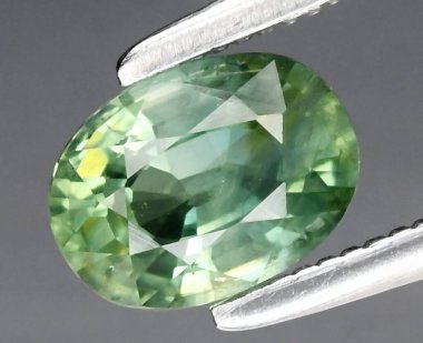 Exquisite Oval-Shaped Green Natural Gemstone Radiating Elegance and Sophistication. clipart