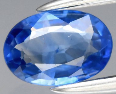 Stunning Deep Blue Natural Sapphire Gemstone Displayed Elegantly on a Silver Prong. clipart