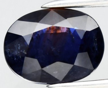 Exquisite Deep Blue Natural Gemstone with Brilliant Faceting and Intriguing Inclusions. clipart