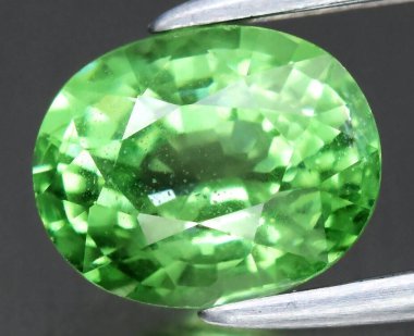 Stunning Green Natural Gemstone with Brilliant Facets and Vibrant Color. clipart