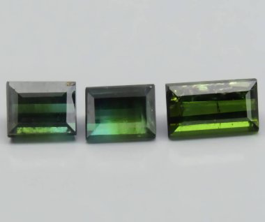 Exquisite Trio of Natural Green Tourmaline Gemstones Displaying Varied Hues and Clarity. clipart