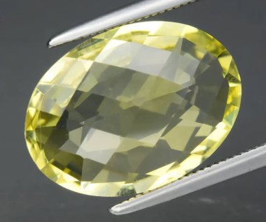 Exquisite Oval Yellow Natural Gemstone with Faceted Surface and Luster. clipart