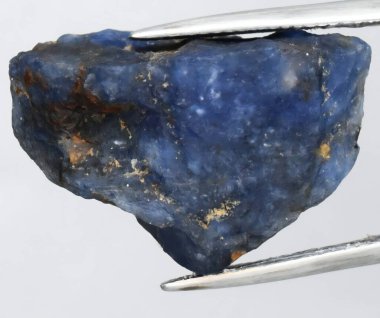 Richly Colored Natural Blue Sapphire Stone with Unique Inclusions. clipart