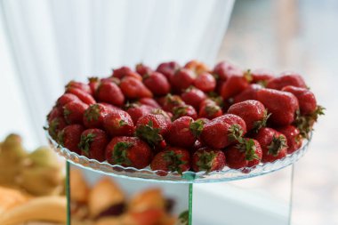 Fresh, Juicy Strawberries Arranged Elegantly on a Glass Dessert Stand. clipart