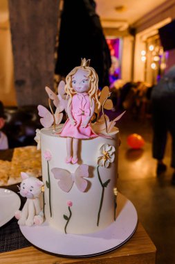 Elaborate Princess-Themed Cake with Fondant Decorations and Cute Accessories. clipart