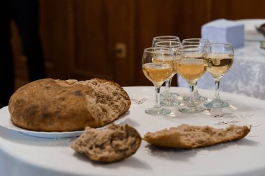 Rustic Bread and Elegantly Served White Wine at a Celebration. clipart