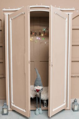 Cozy Holiday Nook with A Gnome in a Vintage Wardrobe. clipart