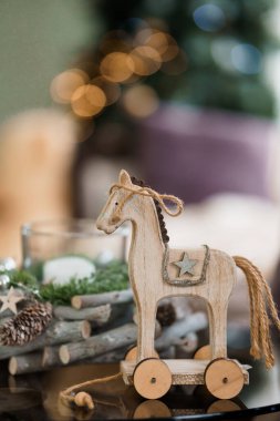 Wooden Toy Horse with Decorative Elements on a Holiday Table Setting. clipart