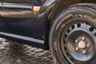 Close-up of a Wet Car Tire and Body in a Cleaning Process. clipart