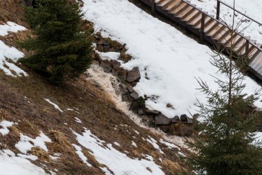 Winter Landscape with Snow-Covered Ground and Flowing Stream. clipart