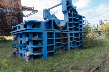 Abandoned Industrial Machinery Surrounded by Nature. clipart