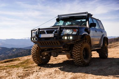 Rugged Off-Road SUV in Mountainous Terrain. clipart