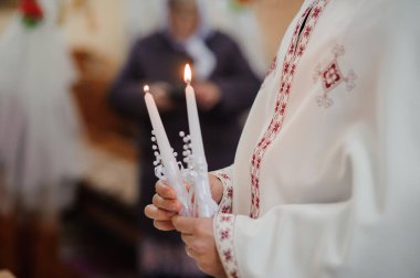 Işığın Seremonisi: Geleneksel Dini Ayarlarda Bir Rahip Mum Tutuyor.