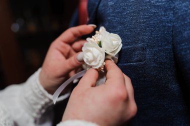 Elegant Wedding Boutonniere Assembly with White Roses and Pearls. clipart