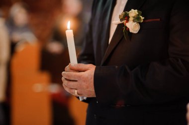 Şık Damat Düğün Töreni sırasında Mum Tutuyor.