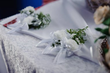 Elegant White Floral Corsages on a Delicate Table Setting. clipart