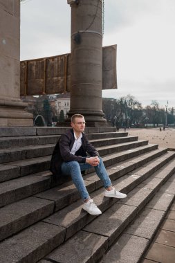 Kentsel Çevrede Taş Merdivenlerde Oturan Genç Adam.